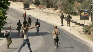 Israeli settlers march through the West Bank town of Sarra as Israeli forces provide security during a march commemorating two Israelis killed a week earlier, July 31, 2026. Clashes erupted along the route, leaving one Palestinian wounded. (AFP)