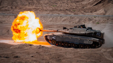 An Israeli Defense Forces Merkava Mark 4 tank fire its 120mm canon