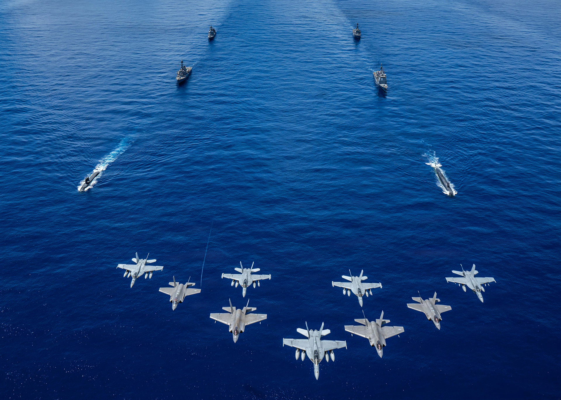 US Navy aircraft, attached to Carrier Air Wing 5, and US Air Force F-35A Lightning IIs fly over US Navy George Washington Carrier Strike Group as it sails in formation with Japan Maritime Self- Defense Force as part of Valiant Shield 2026 on June 21, 2026.