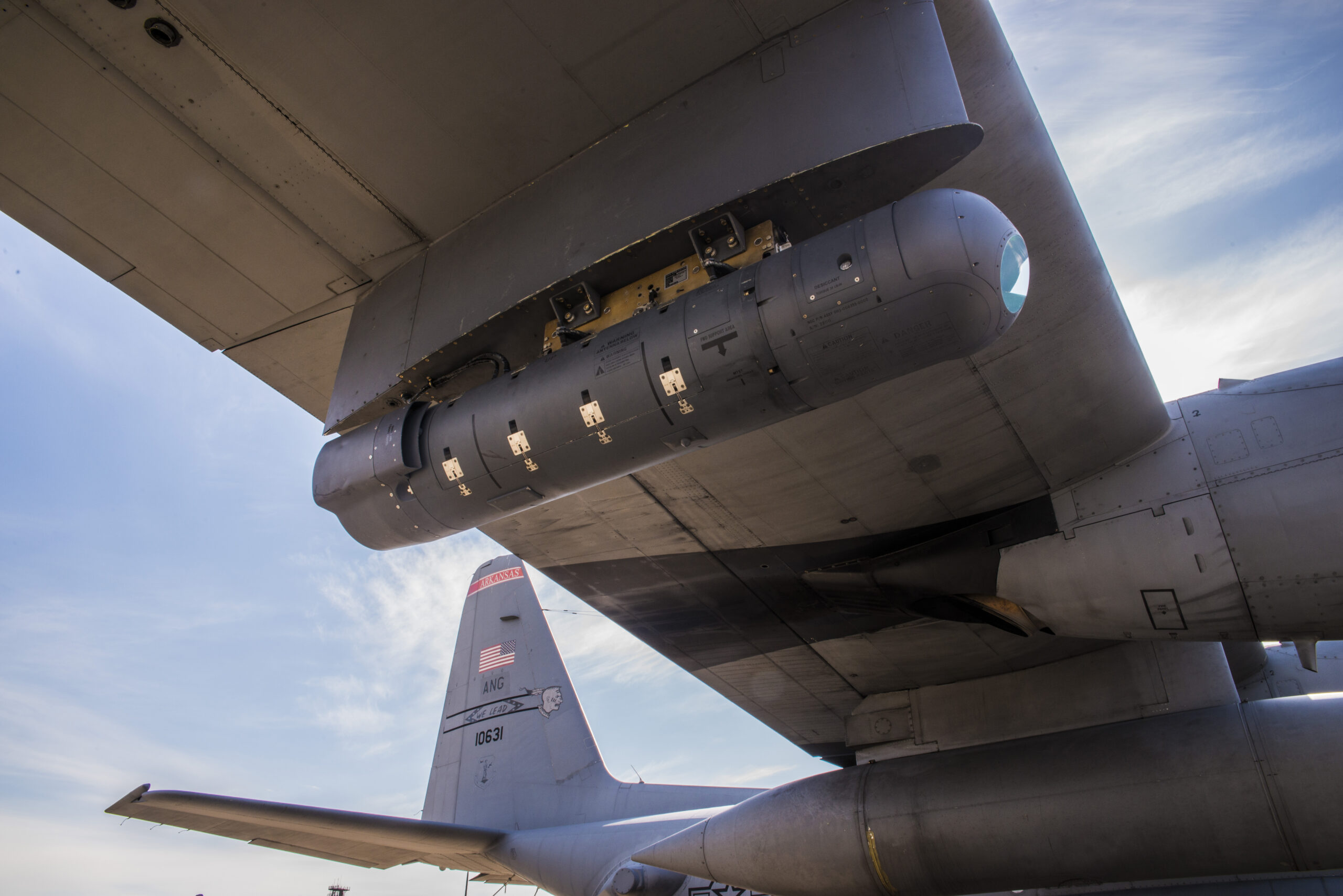 A 189th Airlift Wing C-130H is mounted with a Northrop Grumman LITENING pod targeting system as part of an Air National Guard Air Force Reserve Test Center program to develop a highly-accurate air drop and reconnaissance system. The Arkansas Air National Guard unit has been tapped as a test bed and has sent aircraft, aircrews and maintainers to Arizona for the test program.