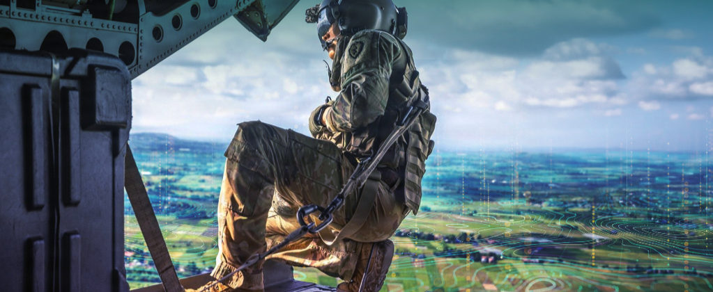 A US Army soldier aboard a helicopter overlooking a digitally enhanced battlefield representing artificial intelligence-enabled operations. Image: Everforth ECS