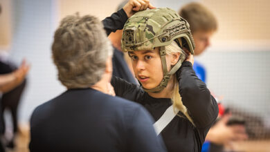 A new conscript in the Air Force tries on the size of the helmet.